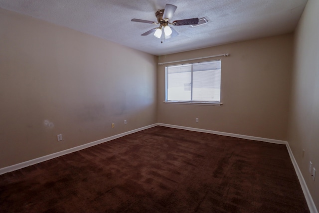 carpeted empty room with ceiling fan and a textured ceiling