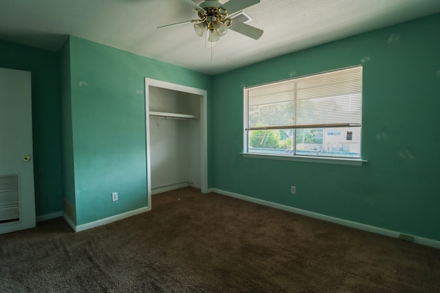 unfurnished bedroom with ceiling fan, carpet, and a closet