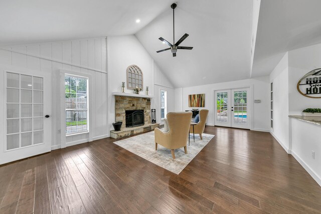 unfurnished living room featuring a wealth of natural light, dark wood-type flooring, and a fireplace