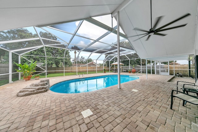 view of swimming pool with a fenced in pool, glass enclosure, a patio area, and a fenced backyard