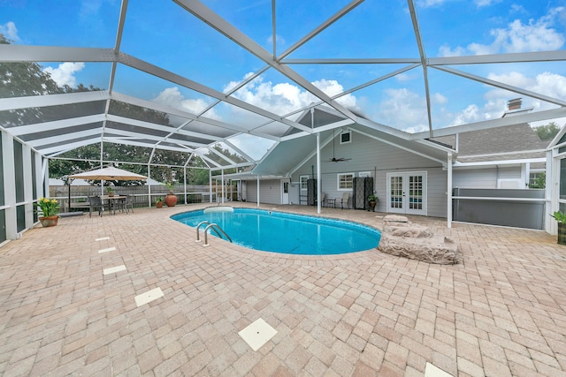 view of pool with ceiling fan, a patio, a lanai, french doors, and a fenced in pool