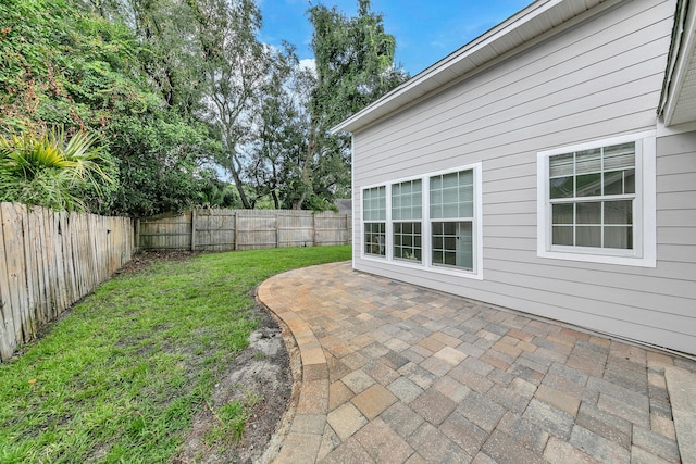 view of yard with a patio area and a fenced backyard