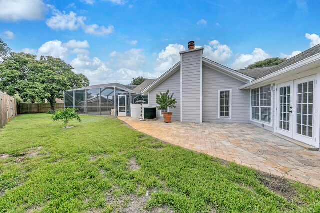 view of yard featuring a patio, cooling unit, and a lanai