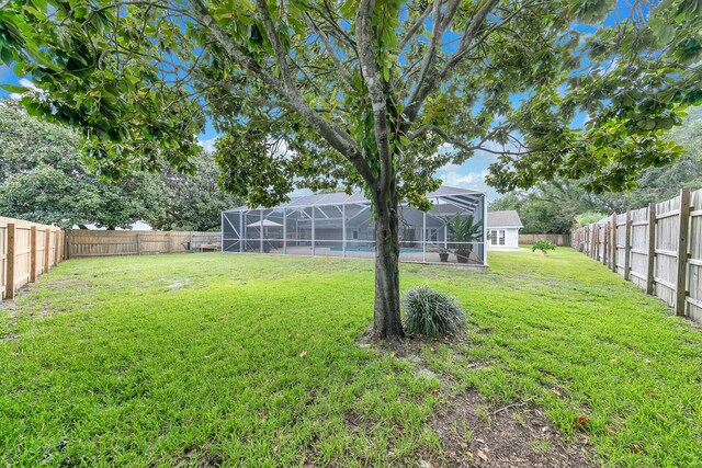 view of yard with glass enclosure