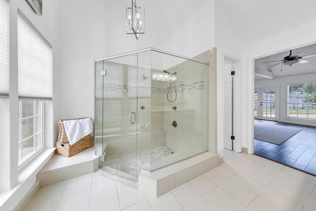 bathroom featuring tile patterned floors, an enclosed shower, and ceiling fan with notable chandelier