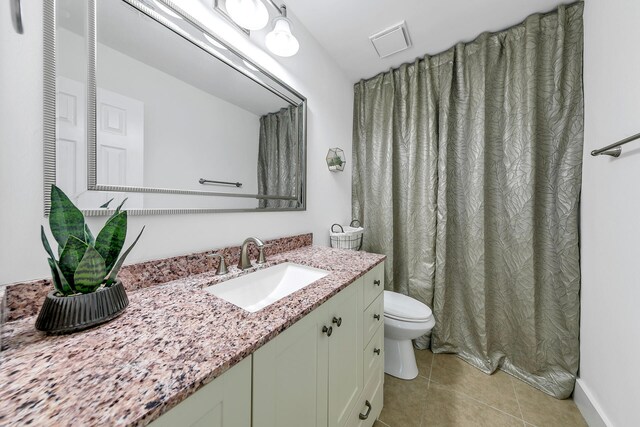 full bathroom with visible vents, vanity, toilet, and tile patterned floors