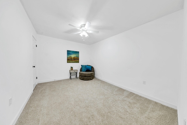 unfurnished room with carpet flooring, a ceiling fan, and baseboards