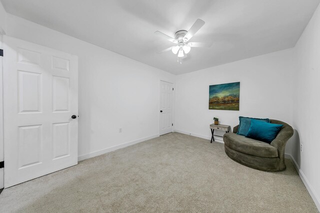 sitting room featuring ceiling fan and light carpet