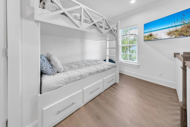 bedroom featuring crown molding and wood-type flooring