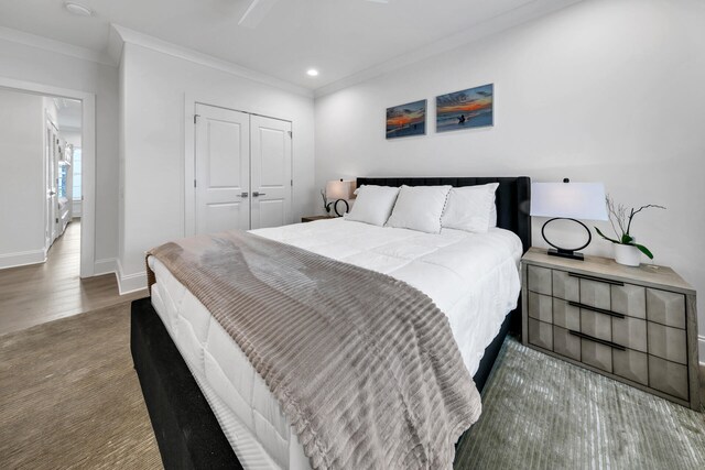 bedroom featuring a closet, ceiling fan, ornamental molding, and wood-type flooring