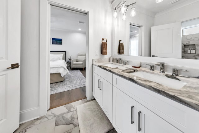 bathroom featuring ornamental molding, vanity, and wood-type flooring