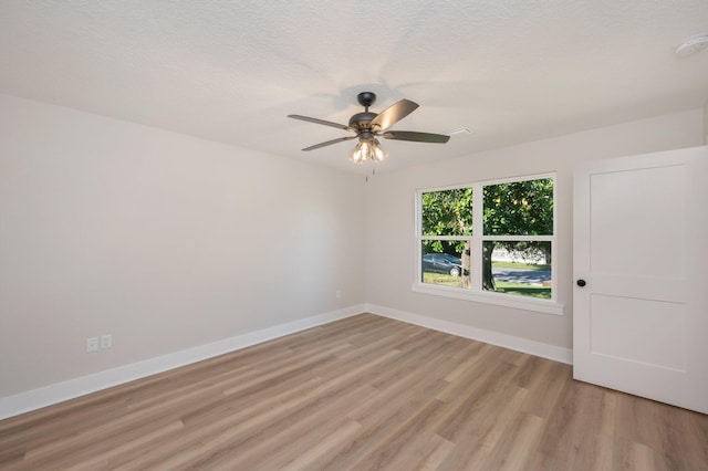 empty room with light wood-type flooring and ceiling fan