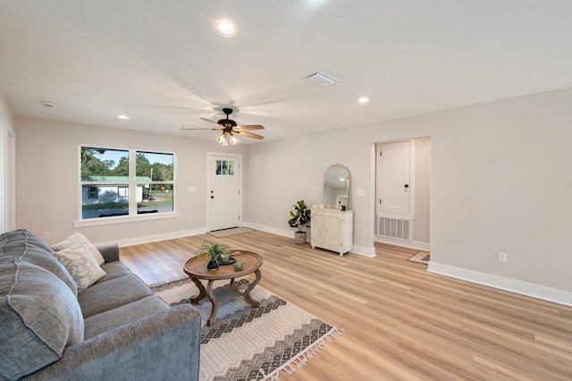 living room featuring light hardwood / wood-style floors and ceiling fan