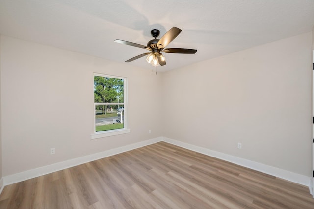 empty room featuring ceiling fan and light hardwood / wood-style flooring