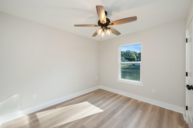 spare room featuring light wood-type flooring and ceiling fan