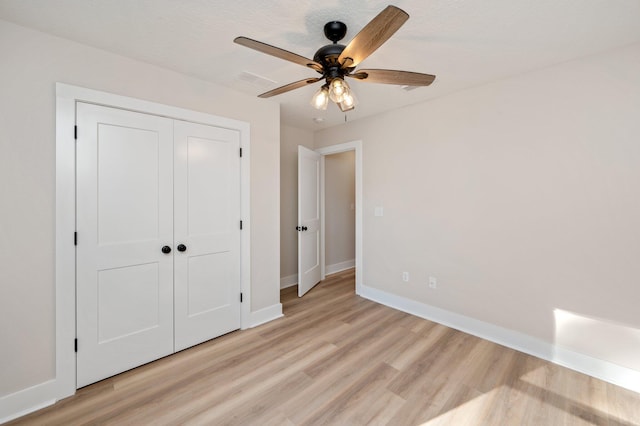 unfurnished bedroom featuring a closet, ceiling fan, and light hardwood / wood-style floors