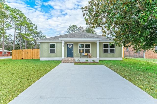 ranch-style home with covered porch and a front yard