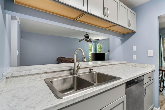 kitchen featuring dishwasher, ceiling fan, gray cabinets, and a sink