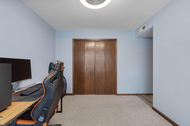 office with visible vents, light carpet, and baseboards