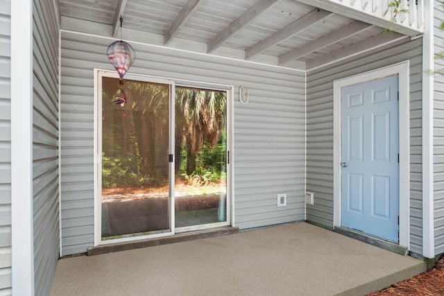 view of exterior entry featuring a patio