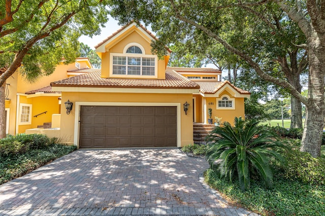 mediterranean / spanish-style home featuring a garage