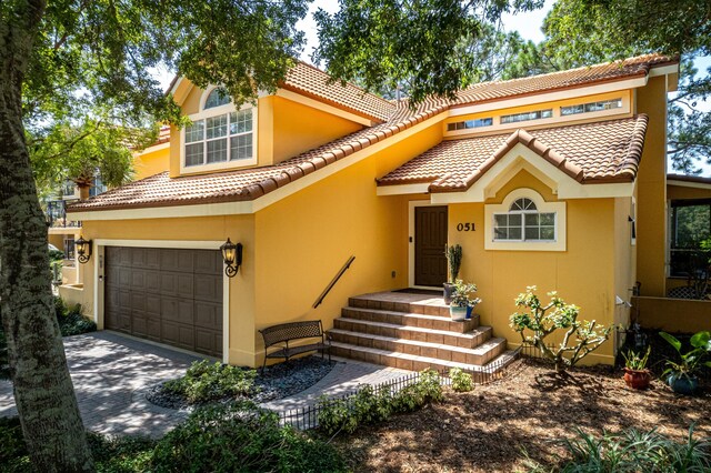 mediterranean / spanish-style home featuring a garage