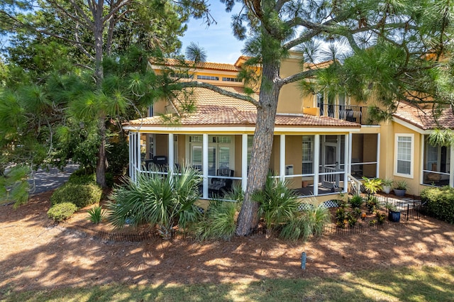 rear view of property featuring a balcony