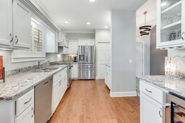 kitchen featuring appliances with stainless steel finishes, sink, light stone counters, wine cooler, and white cabinets