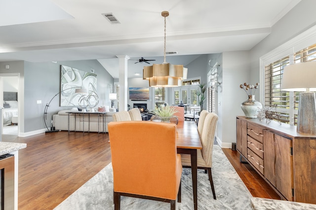 dining room featuring vaulted ceiling, ceiling fan, decorative columns, and dark hardwood / wood-style floors