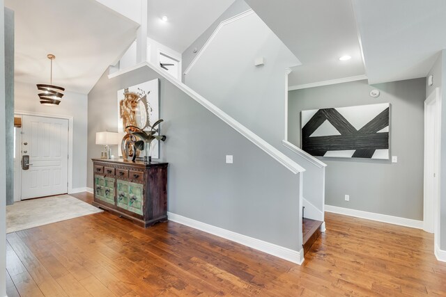 entryway featuring hardwood / wood-style flooring and a towering ceiling