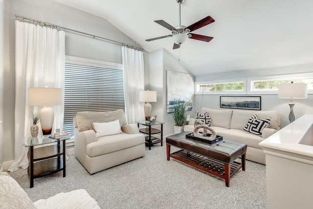 carpeted living room with ceiling fan and vaulted ceiling