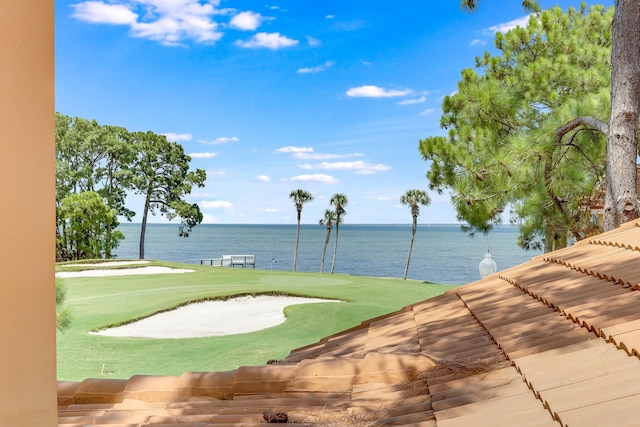 surrounding community featuring a yard and a water view