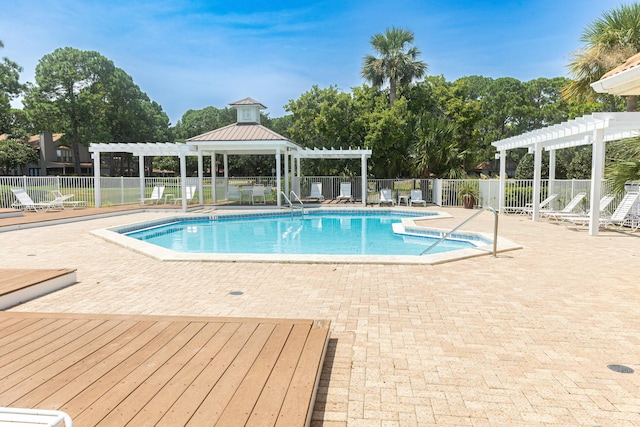 view of swimming pool featuring a pergola and a patio area