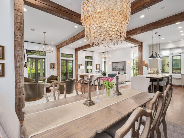 dining area featuring hardwood / wood-style floors, a notable chandelier, french doors, and beamed ceiling