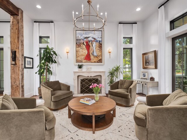 living room featuring an inviting chandelier and a high end fireplace