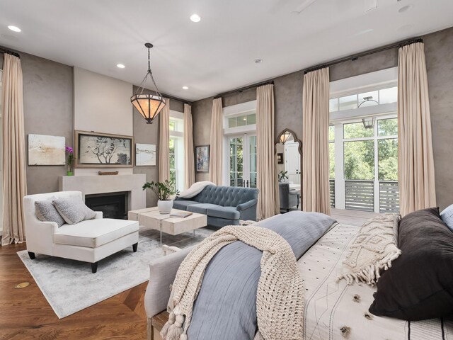 bedroom with hardwood / wood-style floors and multiple windows