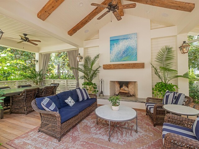 exterior space featuring ceiling fan and vaulted ceiling with beams