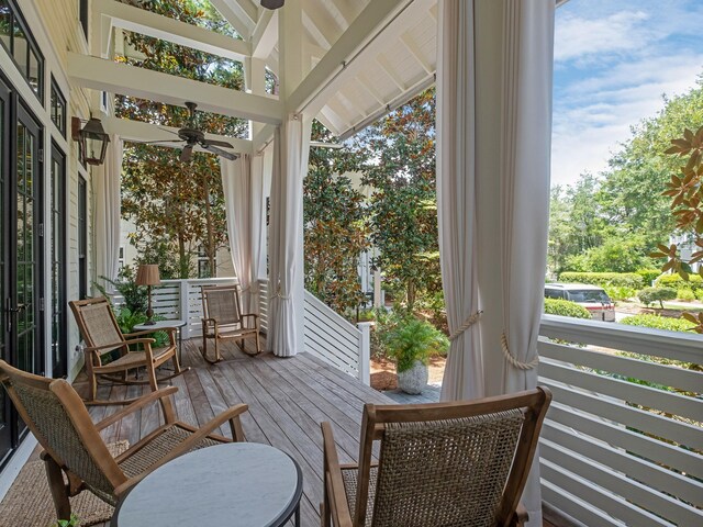 sunroom / solarium featuring ceiling fan