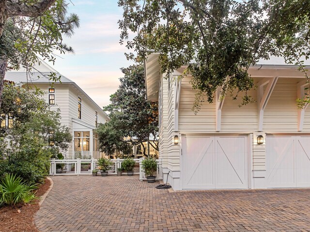 property exterior at dusk with a garage