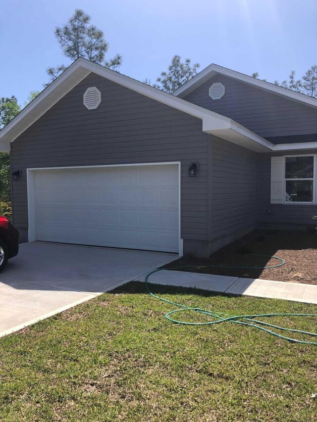 exterior space with a lawn and a garage