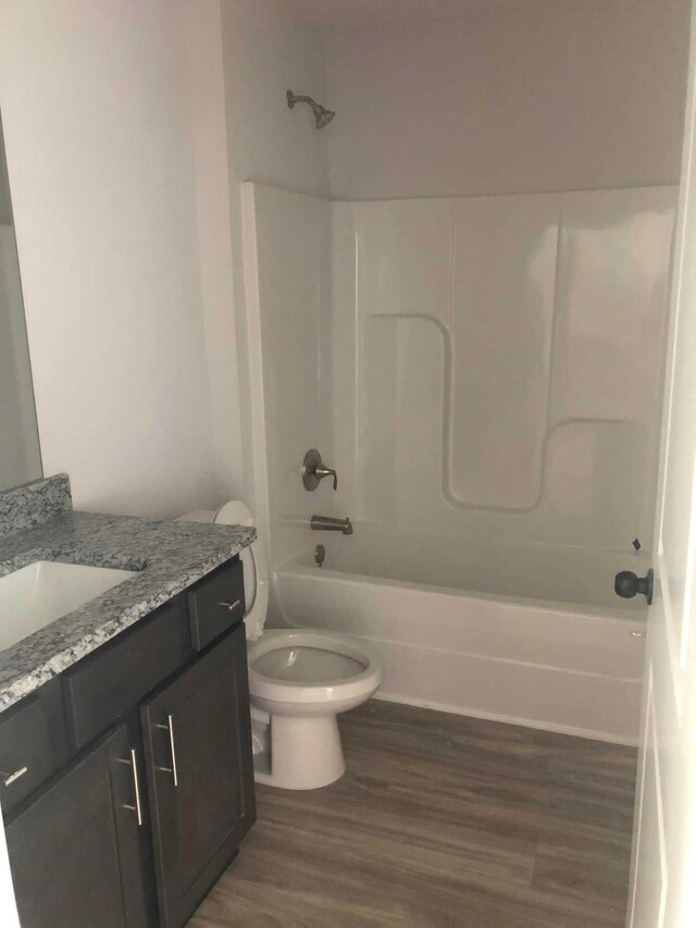 full bathroom featuring toilet, bathtub / shower combination, vanity, and wood-type flooring