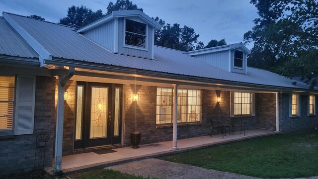 back house at dusk with a patio area