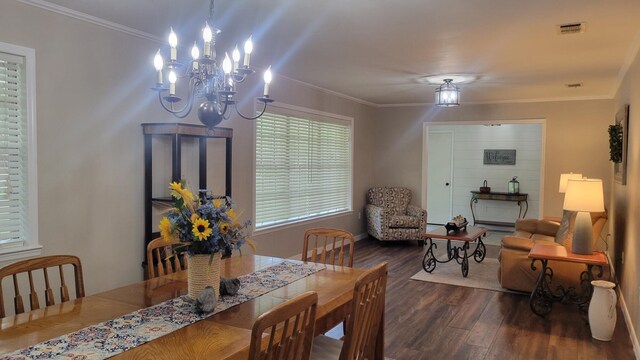 dining space featuring ornamental molding, dark hardwood / wood-style flooring, and an inviting chandelier