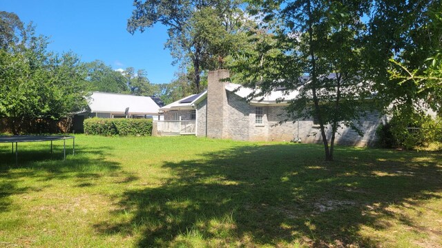 view of yard with a trampoline