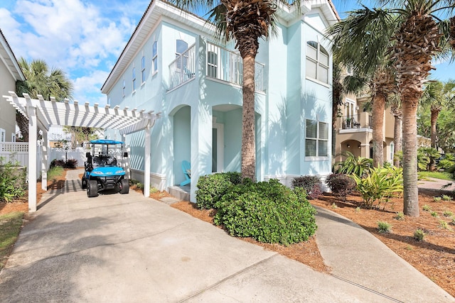 view of front of house featuring a carport and a balcony