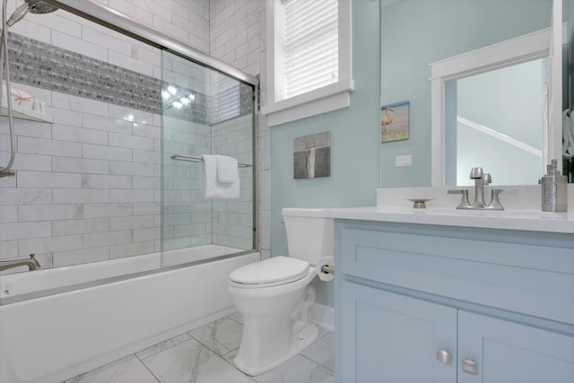 full bathroom with combined bath / shower with glass door, toilet, vanity, and tile patterned floors