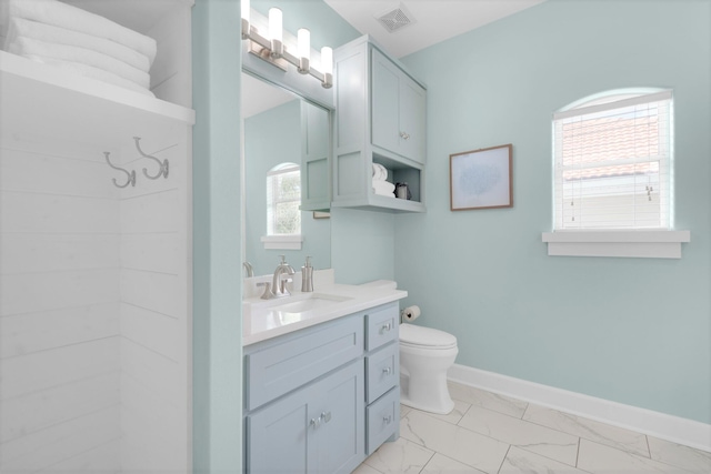 bathroom featuring a shower, tile patterned flooring, vanity, and toilet