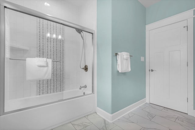 bathroom featuring tile patterned floors and shower / bath combination with glass door