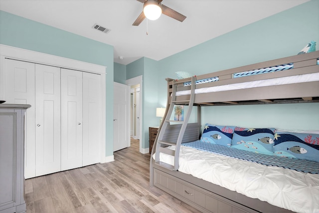 bedroom with ceiling fan, a closet, and light hardwood / wood-style flooring