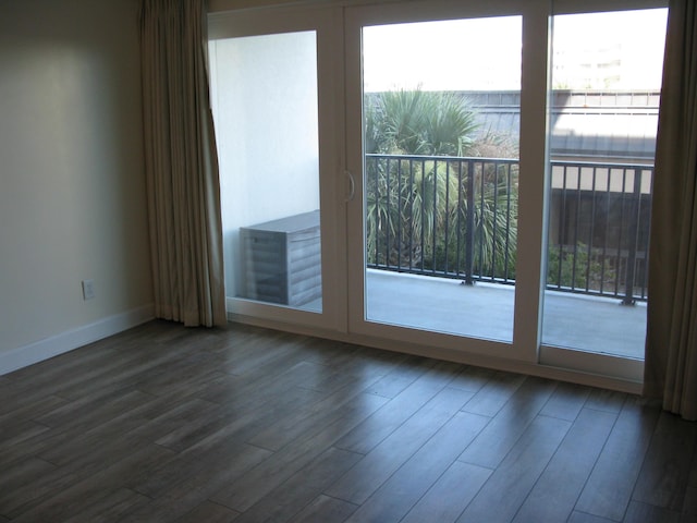 doorway with wood finished floors and baseboards